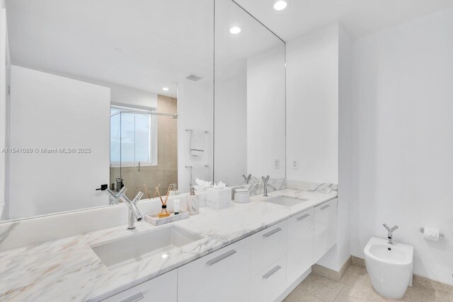 bathroom with vanity, an enclosed shower, and a bidet