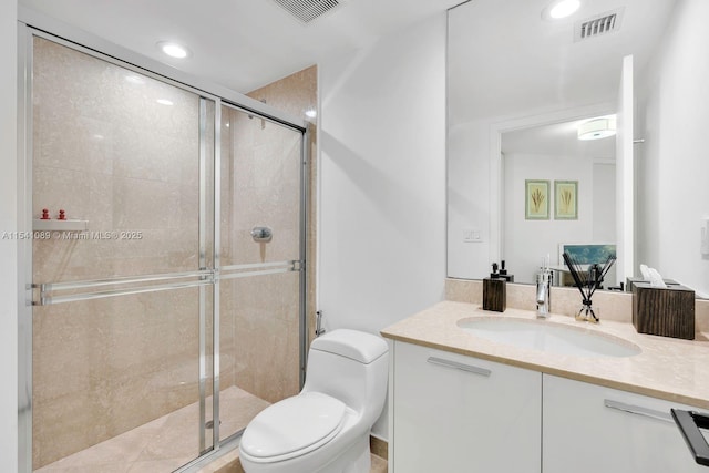 bathroom featuring vanity, toilet, and a shower with door