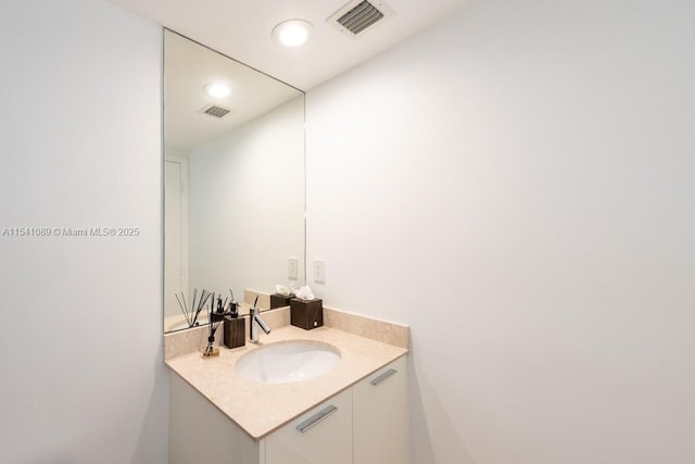 bathroom with vanity, toilet, visible vents, and a stall shower