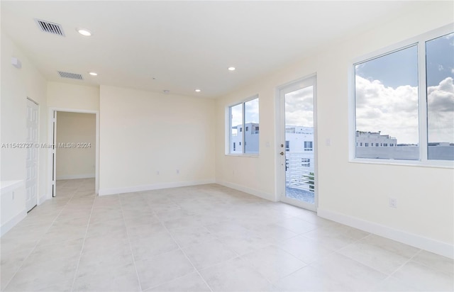 unfurnished room with light tile flooring