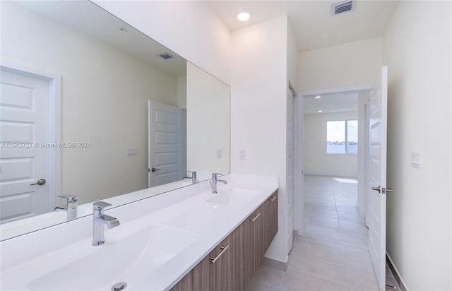 bathroom with double sink vanity and tile flooring