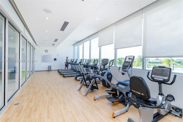 exercise room featuring light wood-type flooring