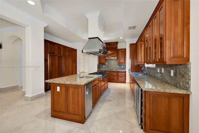 kitchen featuring crown molding, a tray ceiling, light stone countertops, and sink