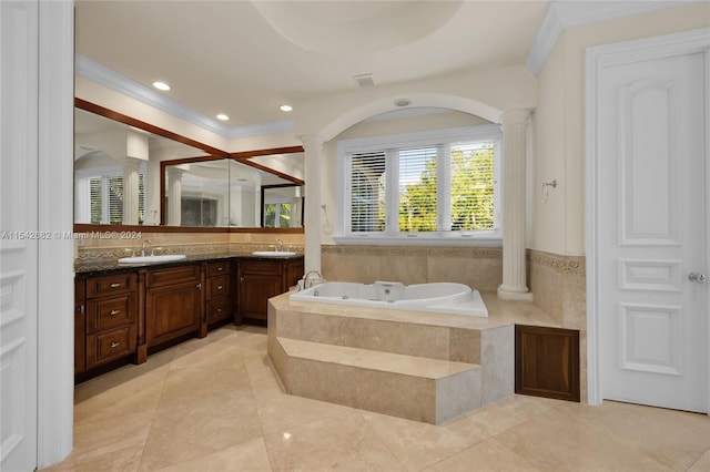 bathroom with ornate columns, vanity, tiled bath, and crown molding