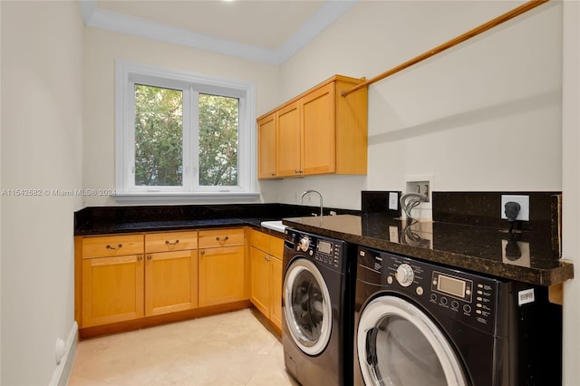 laundry area featuring cabinets, crown molding, sink, and washing machine and clothes dryer