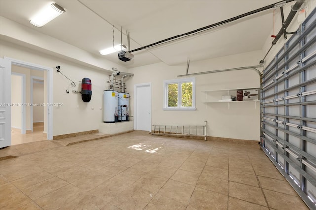 garage featuring a garage door opener, strapped water heater, and water heater