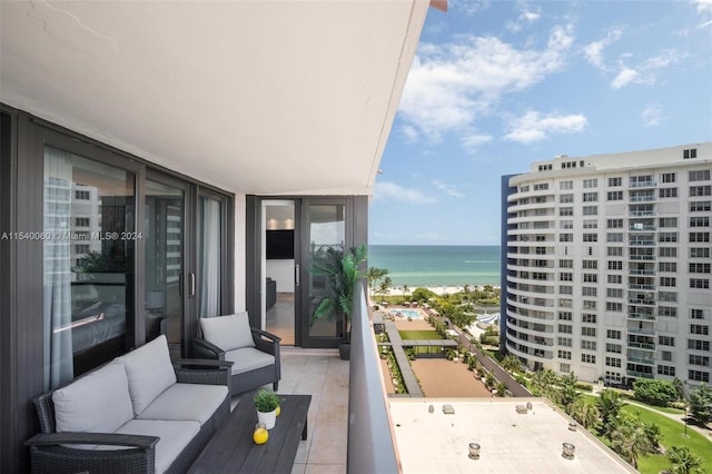 balcony with outdoor lounge area and a water view