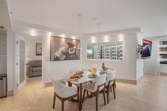 dining space featuring light tile floors