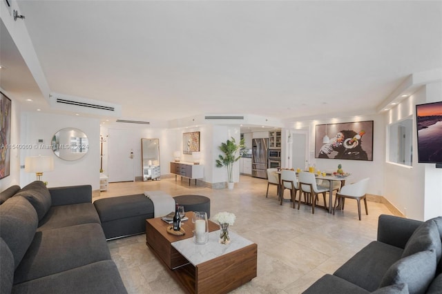 living room featuring light tile floors and a wall mounted air conditioner