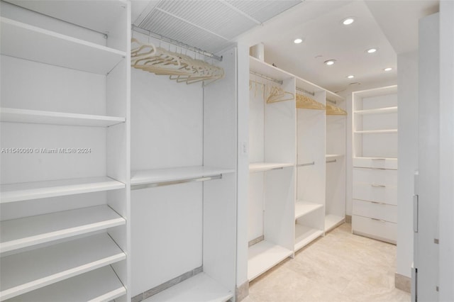 walk in closet featuring light tile floors