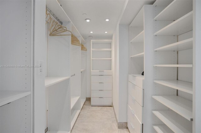 spacious closet with light tile flooring