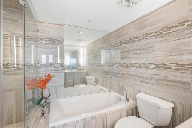 bathroom featuring tiled bath, tile walls, and toilet