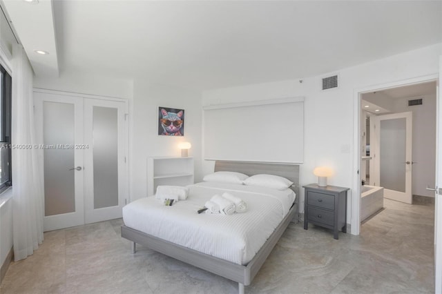 tiled bedroom featuring french doors