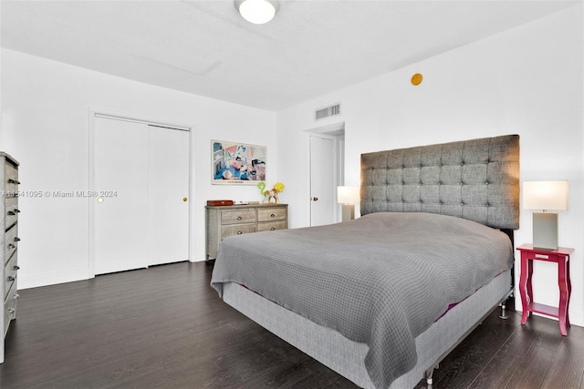 bedroom with a closet and dark hardwood / wood-style floors