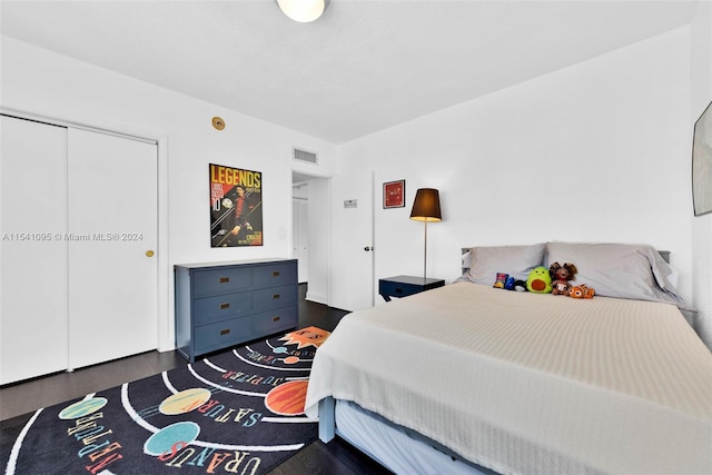 bedroom featuring a closet and dark hardwood / wood-style floors