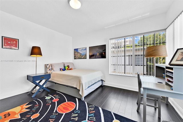 bedroom with dark wood-type flooring