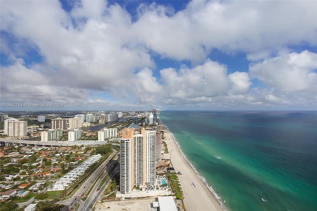 bird's eye view with a water view and a view of the beach