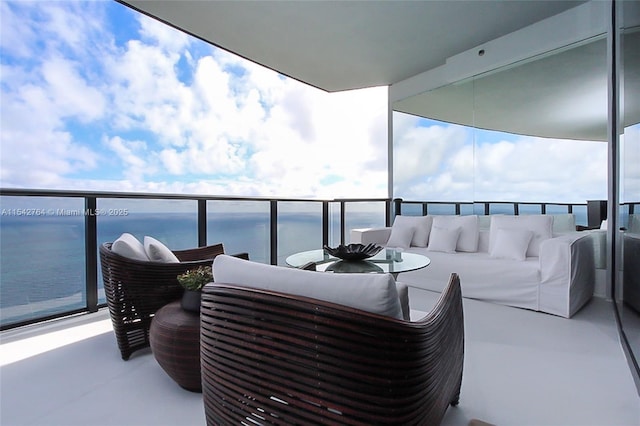 balcony with a water view and an outdoor hangout area