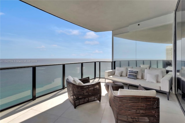 balcony with outdoor lounge area and a water view