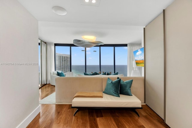 living area with wood finished floors and baseboards