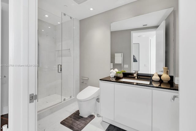 bathroom with tile patterned floors, a shower stall, toilet, and vanity