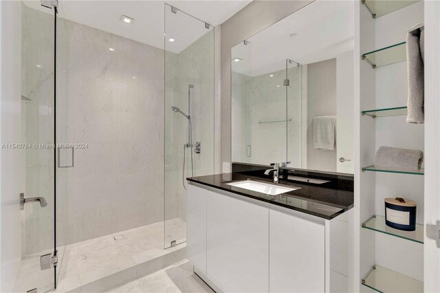 bathroom featuring tile flooring, large vanity, and walk in shower