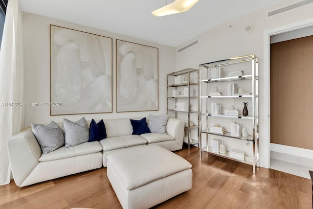 living room featuring visible vents and wood finished floors