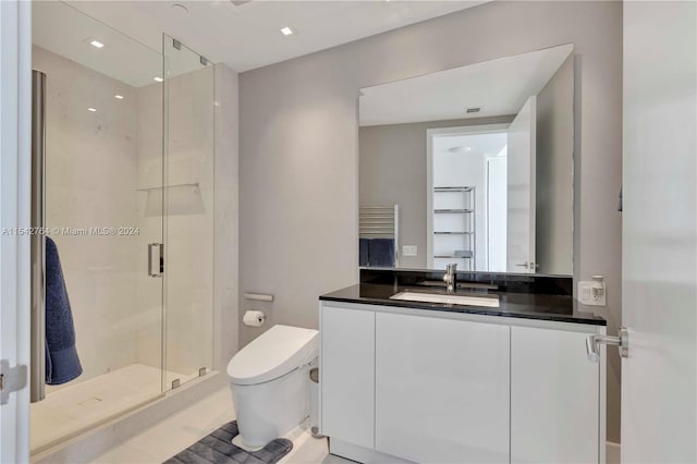 bathroom featuring toilet, tile floors, an enclosed shower, and vanity