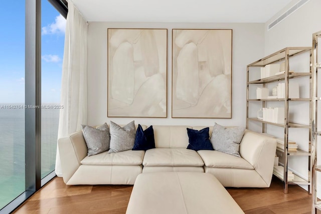 living room with expansive windows and wood finished floors