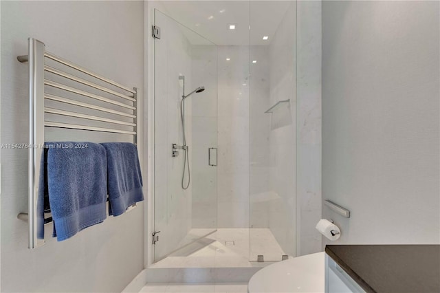 bathroom with radiator heating unit, toilet, and an enclosed shower