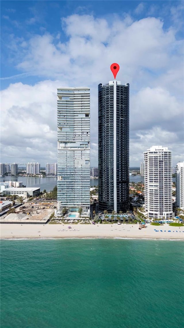 drone / aerial view featuring a view of the beach and a water view