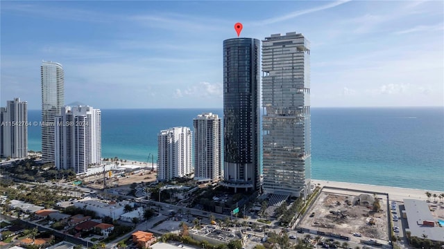 view of city with a beach view and a water view