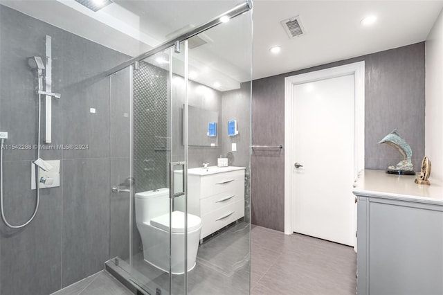 bathroom featuring walk in shower, tile patterned floors, vanity, and toilet