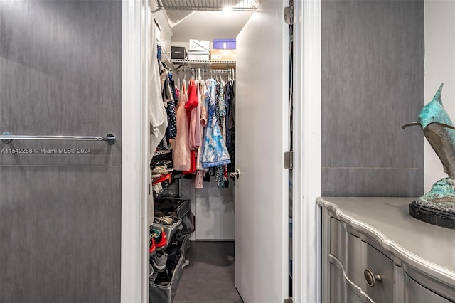 walk in closet with tile patterned flooring