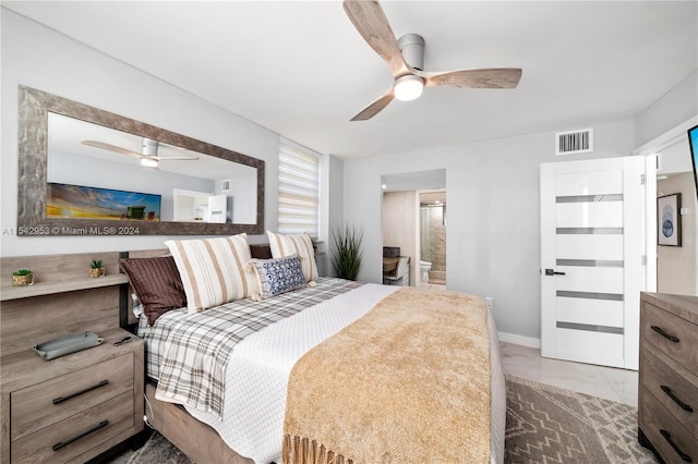 bedroom featuring tile patterned floors, ceiling fan, and ensuite bathroom