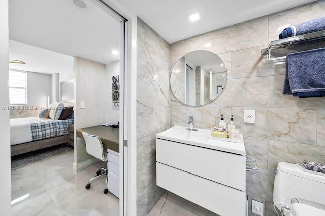 bathroom featuring toilet and tile walls