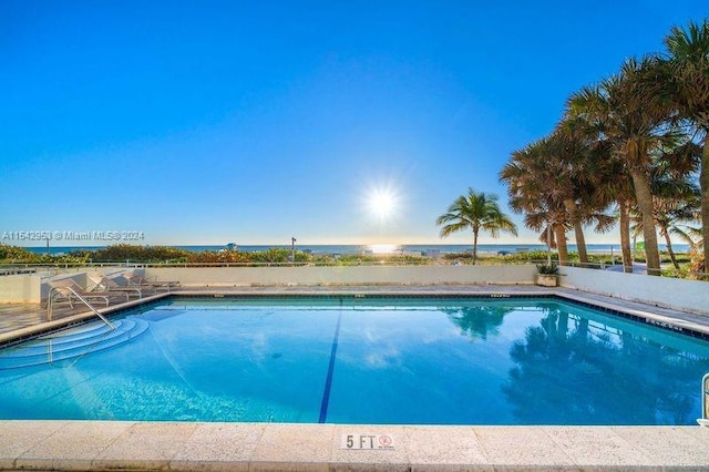 view of pool featuring a water view