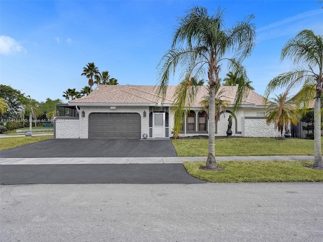 view of front of home featuring a front lawn and a garage