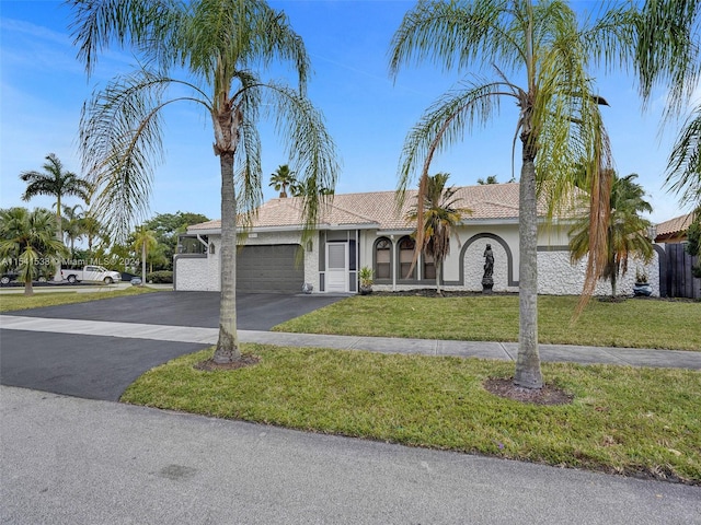 view of front of property with a front lawn and a garage