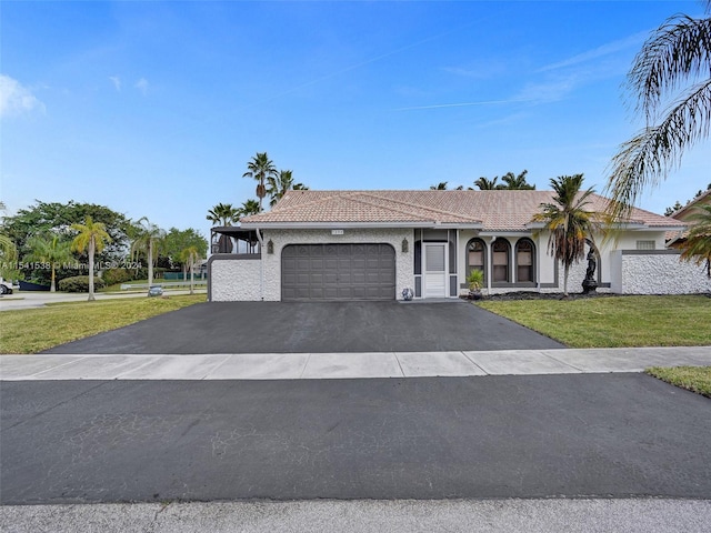 view of front of house featuring a front yard and a garage