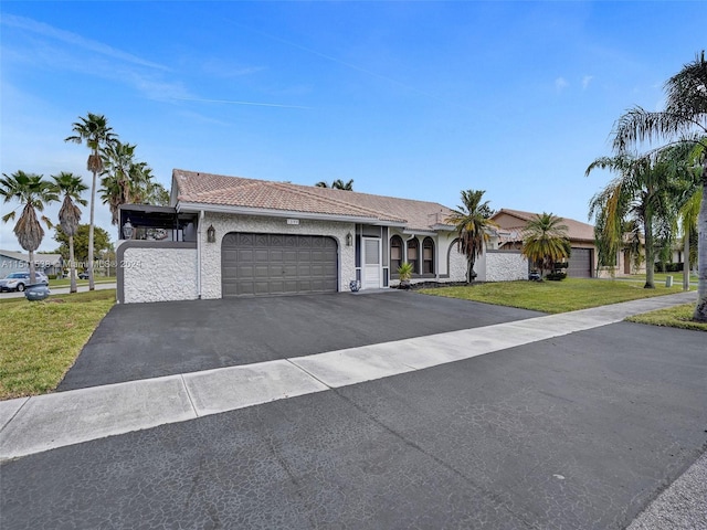 ranch-style home with a front lawn and a garage