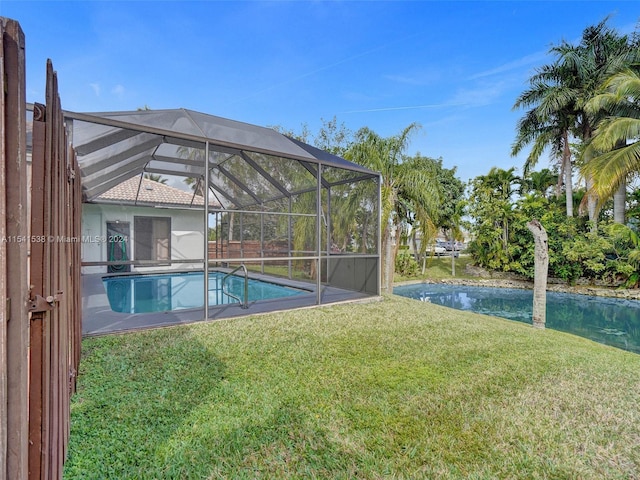 view of swimming pool with a lawn and glass enclosure