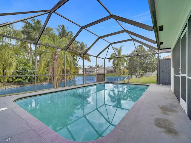 view of swimming pool featuring a patio and a lanai