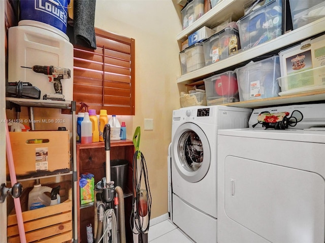 laundry area featuring washing machine and dryer and light tile flooring