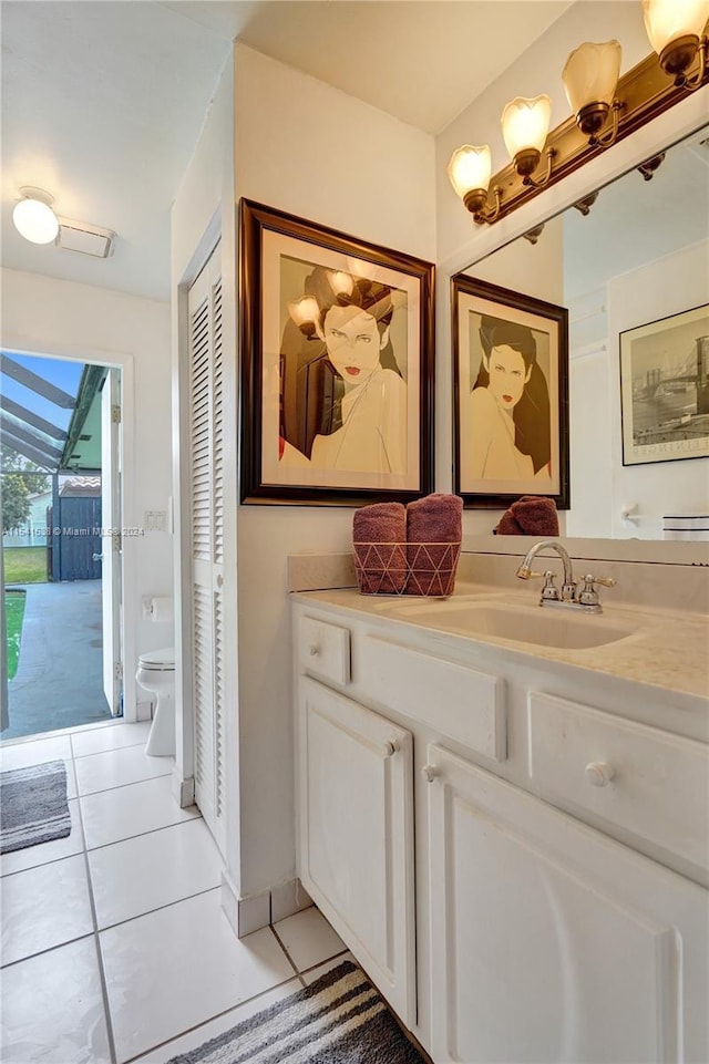 bathroom featuring toilet, tile flooring, and vanity