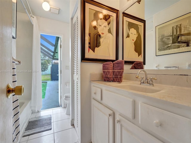 bathroom featuring toilet, large vanity, and tile flooring