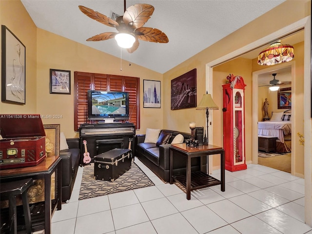 living room featuring vaulted ceiling, light tile flooring, and ceiling fan