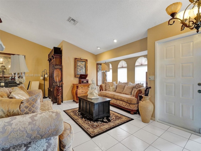 living room featuring an inviting chandelier, a textured ceiling, light tile floors, and lofted ceiling