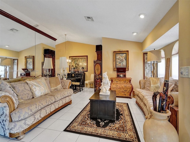 tiled living room with an inviting chandelier and vaulted ceiling