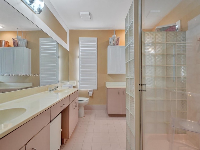 bathroom featuring double sink, walk in shower, tile flooring, toilet, and oversized vanity